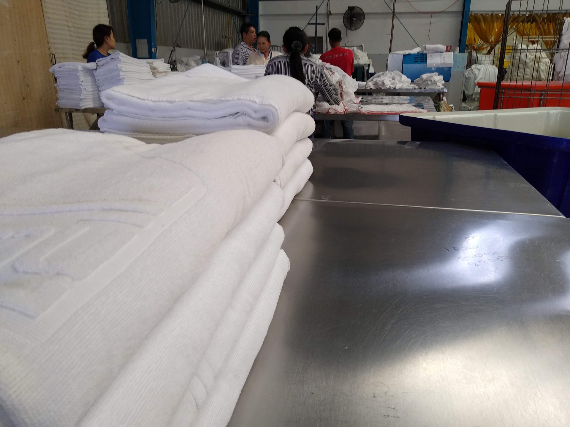 Clean hospital and hotel linen folded and stacked ready for delivery at Ideal Laundry